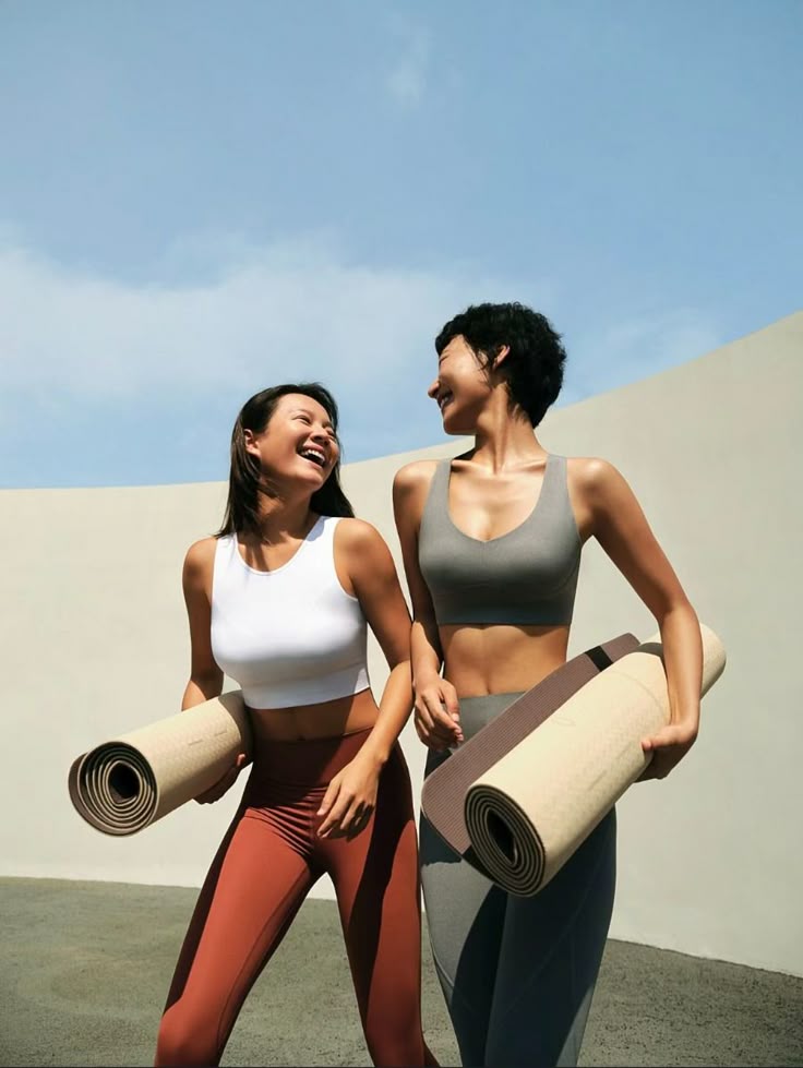 Friends heading to yoga with their mats